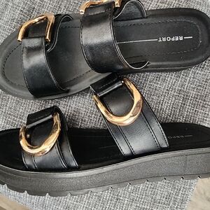 Report Gold and Black Sandals with Metallic Buckles